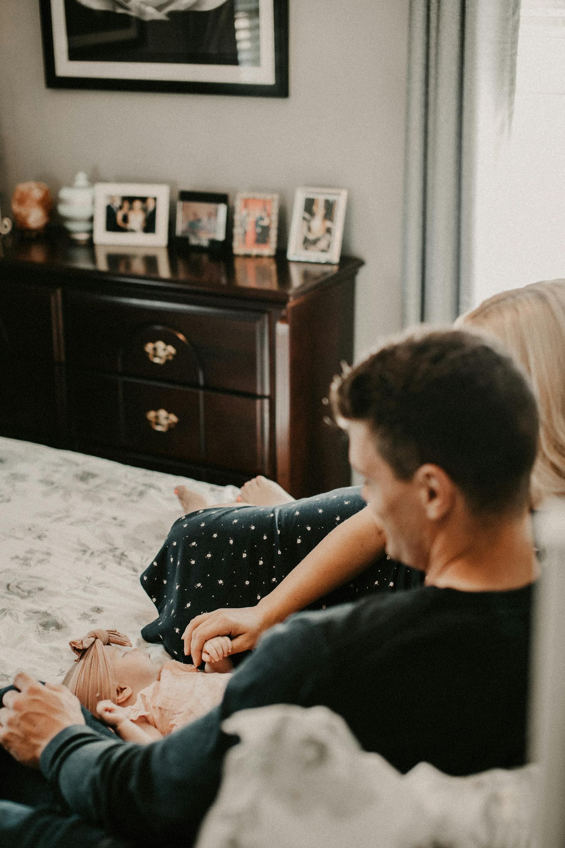 Family relaxing at home with their newborn baby.